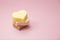 Heart shaped pink bar of soap on a light pink background. Top view, copy space. Heart shaped soaps. Importance of