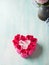 Heart shaped pink red roses on pastel color