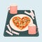 Heart shaped pizza, candies and two pink cups of hot coffee and marshmallows are on the tray on blue background