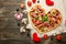 Heart-shaped pizza, Valentine`s Day. With vegetables. A concept of tasty and healthy food with love. Free-lay