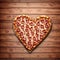 Heart-shaped pizza on wooden table, top view generative ai