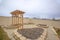 Heart shaped planting beds and wooden arbor at the yard of a home