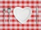 Heart shaped plate, fork, spoon and knife top view