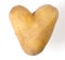 Heart shaped potato on white background