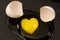 Heart shaped raw egg yolk