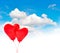 Heart shaped red balloons in blue sky. Valentines Day background