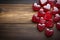 Heart shaped red candies adorn a wooden background for a sweet and festive touch