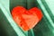 Heart shaped small decorative pillow on soft green pouffe