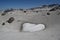 Heart shaped snowfield in the mountains