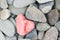 Heart shaped stone painted on red