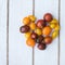 Heart shaped tomatoes. white wood background. soft focus. top view