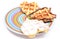 Heart shaped waffles lying on colorful plate. White background