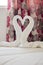 Heart shaped white towels in a romantic honeymoon hotel room for newly weds in Rhodes, Greece