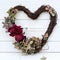 A heart shaped wreath with a thank you with dried roses and hydrangea petals