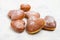 heart sheped donuts with powdered sugar on white background.