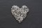 Heart of stones, love. Scattered diamonds on black background. Raw diamonds and mining, a scattering of natural diamond stones.