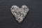 Heart of stones, love. Scattered diamonds on black background. Raw diamonds and mining, a scattering of natural diamond stones.