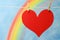 The heart symbol with a blue sky and colorful rainbow.