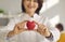 Heart symbol in hand of smiling female doctor cardiologist with stethoscope