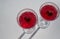 Heart symbol inside crystal glasses with red alcoholic drink for two