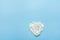 Heart Symbol Made from White Flower Petals on Blue Background. Valentine Mother`s Day Romantic Love Purity