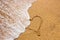 Heart symbol on the sand. Summer holiday concept. Romantic love background. Valentin Day theme. Top view. Heart drawn in sea beach