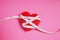 Heart tape measure on a pink background