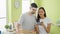 In the heart of their home\\\'s laundry room, a sweetly smiling beautiful couple shares a funny video on their smartphone, amidst a
