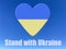 Heart with Ukrainian flag above slogan Stand with Ukraine