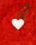 Heart white on a vibrant red soft dusty background with small green hearts coming out of it. Valentine love aesthetic design