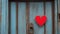 heart on wooden door A blank wood sign with a red heart on a blue door. The sign is old and worn, and the heart is cozy
