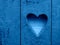 Heart on wooden rustic wall. Heart sign, hole. classic blue colour. Classic blue color heart pattern