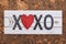 Heart xoxo hugs and kisses wooden sign on cork