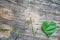 Heartbeat line from grass and leaf on old wooden background, living in harmony with nature concept