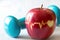 Heartbeat line on red apple and dumbbell, healthy heart diet and sport concept