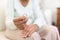 Heartbroken elderly woman holding a wedding ring