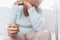 Heartbroken elderly woman holding a wedding ring