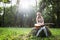 Heartbroken woman in nature with guitar