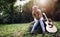 Heartbroken woman in nature with guitar