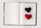 Hearts on blank notebook on white background