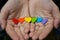 Hearts of the color of the rainbow in women`s hands. The LGBT S