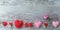 Hearts, fresh rose, decor on a wooden background, for a congratulation on a romantic holiday