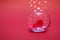 Hearts in a round transparent vase on a red bokeh background with hearts. Valentine's day or mother's day