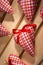 hearts sewn from red plaid fabric on the board,