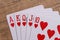 Hearts suit playing cards on wooden