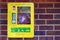 Heartstart Defibrillator in a medical box on a brick wall