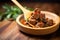 hearty beef goulash on wooden spoon, close view