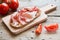 Hearty bread with ham bacon on a wooden board