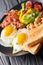Hearty breakfast: fried eggs with bacon, beans, toast and fresh