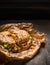 Hearty Breakfast Sandwich on a Bagel with chiken and salad leaves and Cheese on rustic wooden background, close up